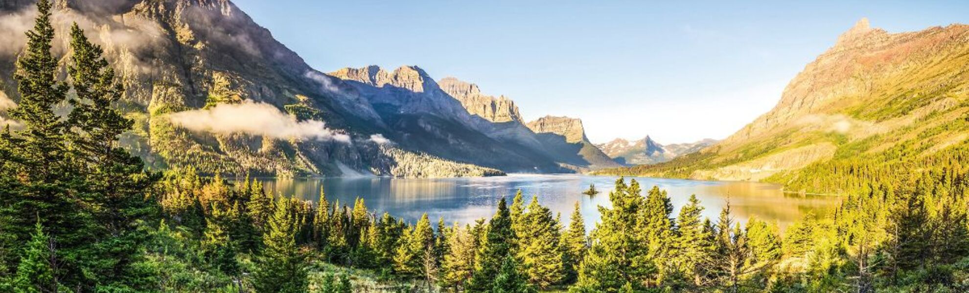 Panoramic landscape view of Glacier NP mountain range and lake